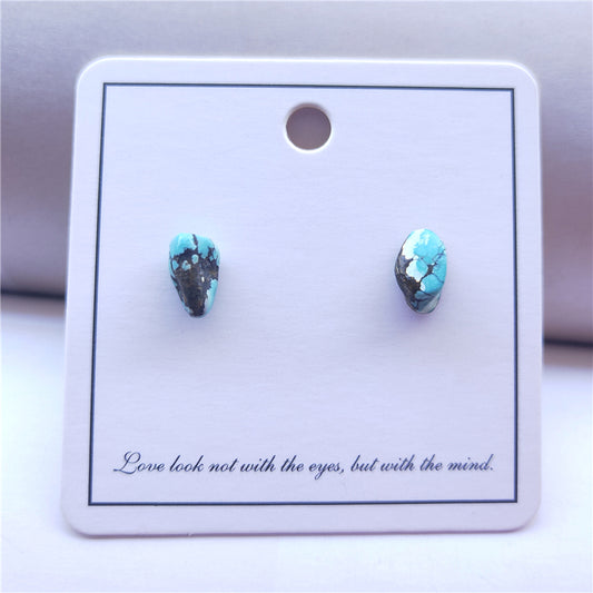 Turquoise teardrop earrings on a white card with text