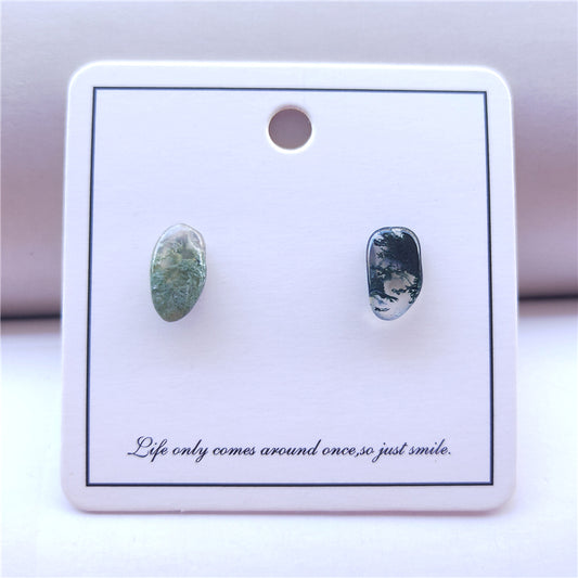 Pair of green earrings on a white card with text