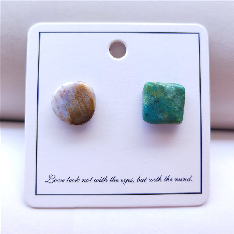 Pair of stone earrings on a display card with a quote.