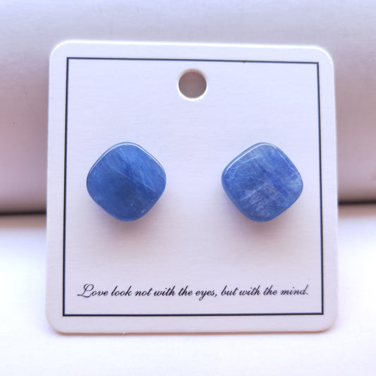 Blue square earrings on a white card with text